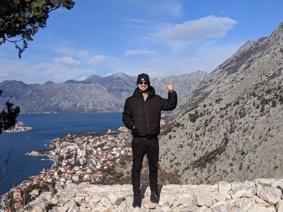 photo of me with mountains, city and lake/sea in the background